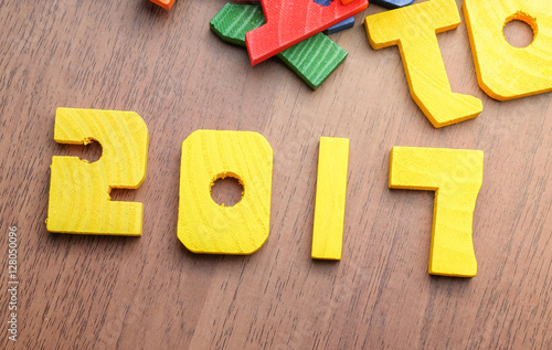 2017 new year number yellow color toy on wood table with other f
