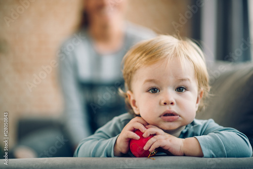Mom playing with her son in cosy living room