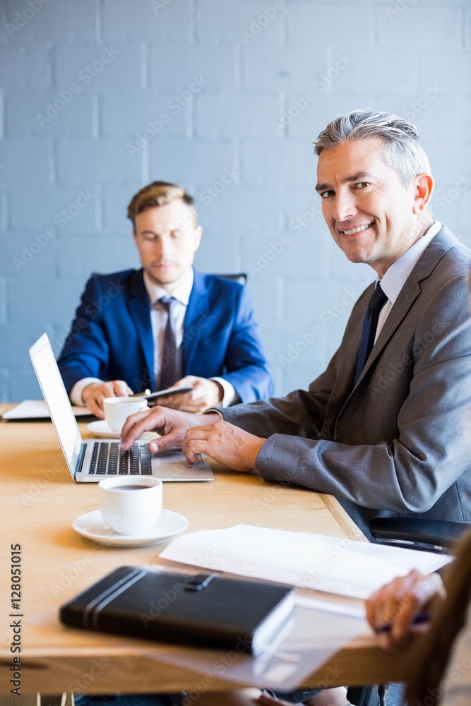 Fototapeta premium Businessman working on laptop in a meeting