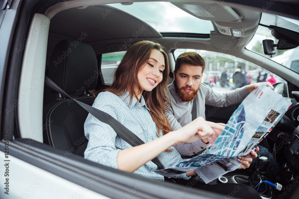 Couple in car with map Couple in car with map
