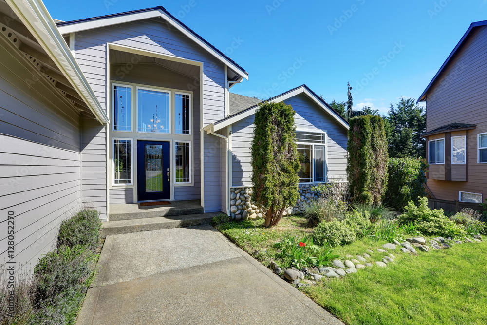 Blue siding house with elegant front door and side windows Blue siding house with elegant front door and side windows