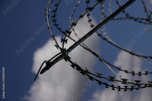 Barbed wire in a blue sky