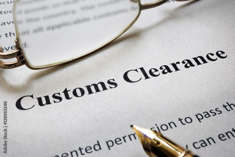 Page of paper with words Customs Clearance and glasses. Page of paper with words Customs Clearance and glasses.