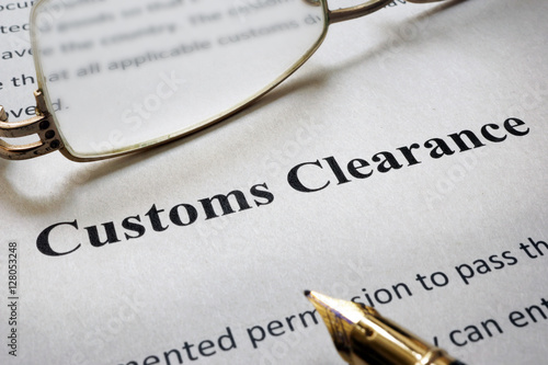 Tableau sur toile Page of paper with words Customs Clearance and glasses.