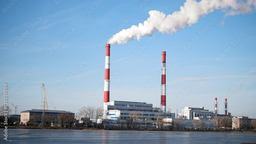 Smoking power plant at sunny day, white vapor from red tube Smoking power plant at sunny day, white vapor from red tube