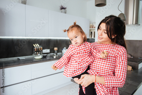 Mother with daughter on kitchen