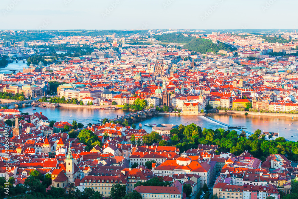 Panorama of the old part of Prague from the Petrin tower. Beautiful view on the bridges over the river Vltava at sunset. Old Town architecture, Czech Republic.