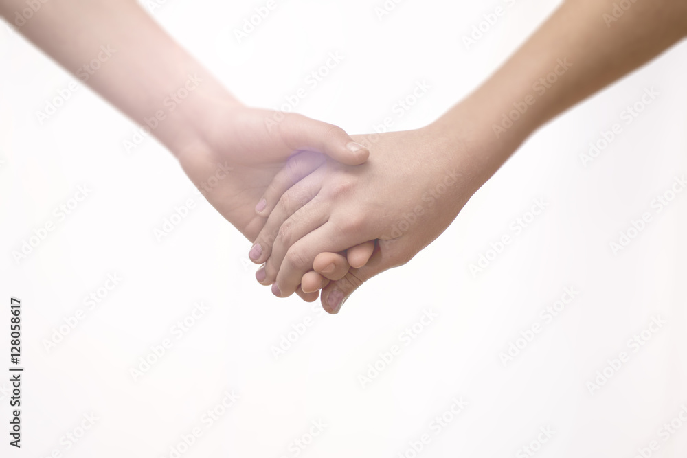 Young Couple Holding Hands Closeup. Friendship, Love and Valentine’s Day Concept.