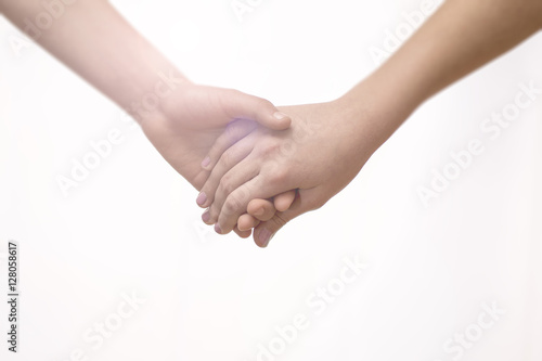 Young Couple Holding Hands Closeup. Friendship, Love and Valentine’s Day Concept.