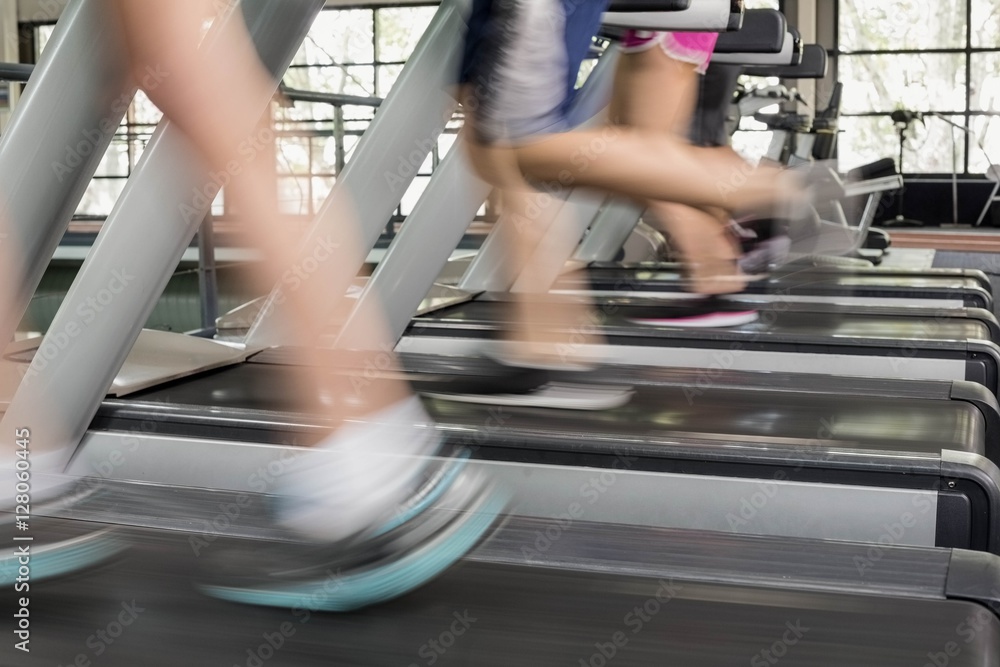 Women and men running on a treadmill
