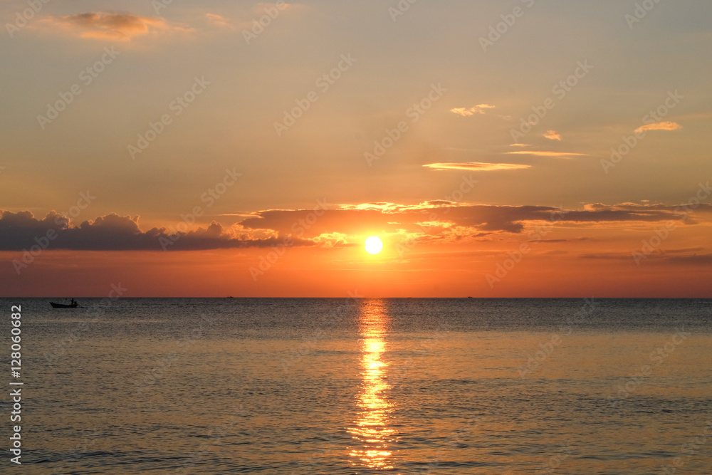 Sunset at sea with boat at Chaolao Tosang Beach Thailand.