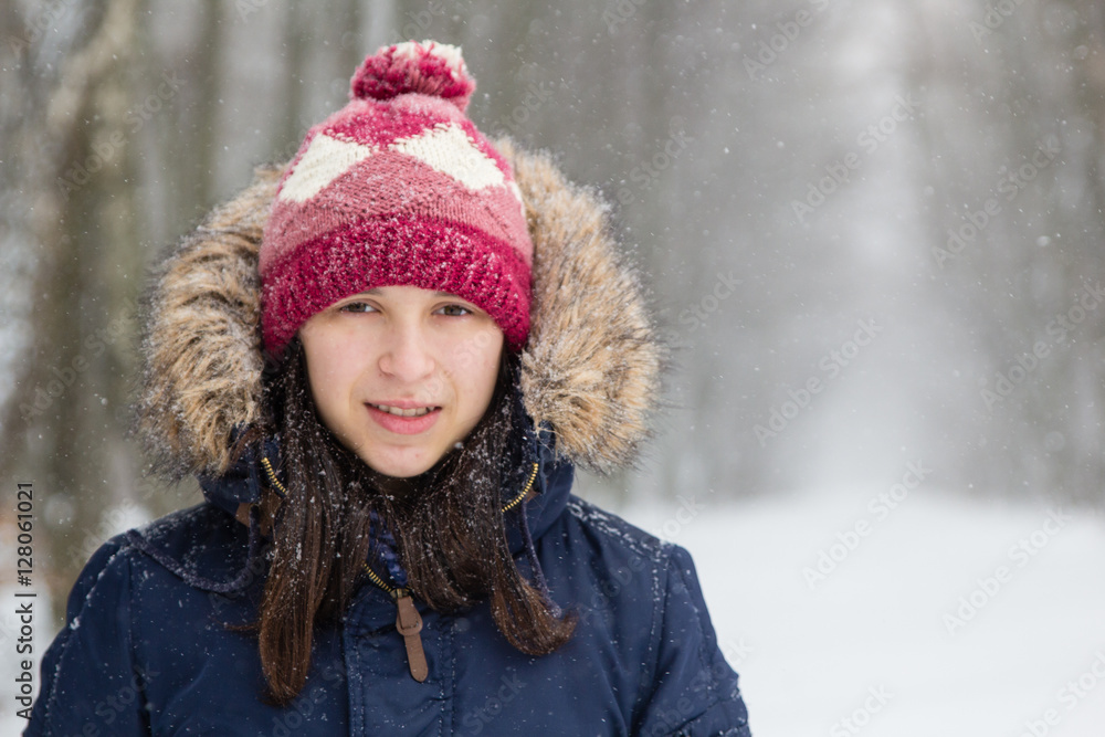 Girl in white snowy forest during beautiful snowfall Girl in white snowy forest during beautiful snowfall