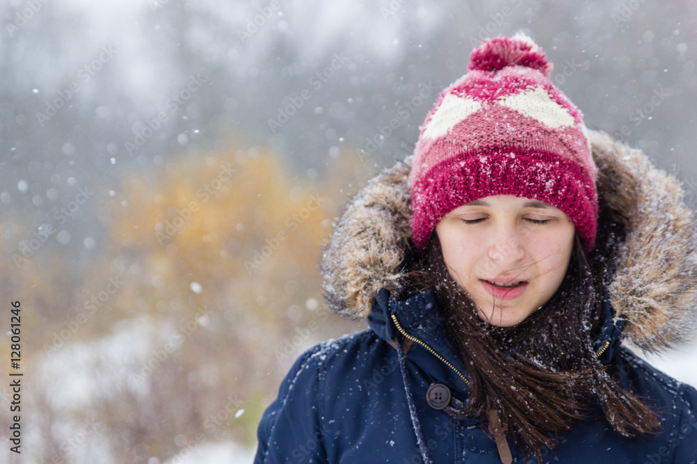 Girl in white snowy forest during beautiful snowfall Girl in white snowy forest during beautiful snowfall