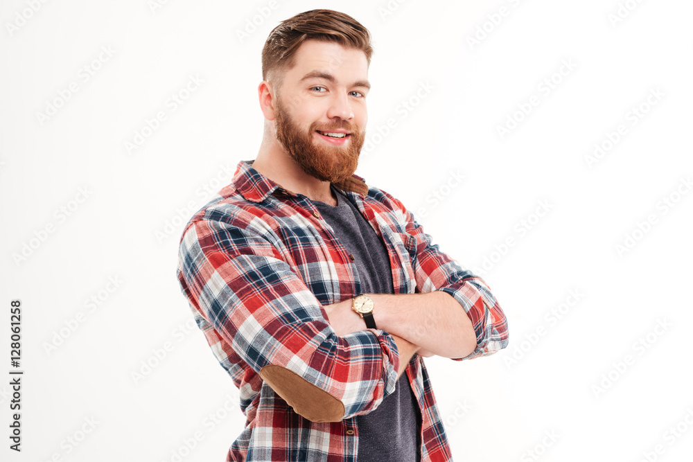 Man in plaid shirt with arms folded looking at camera Man in plaid shirt with arms folded looking at camera