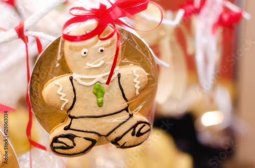 Closeup of a gingerbread man hanging from a christmas tree as a decoration