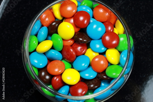 Chocolate coated with Rainbow candy on the Black Background photo