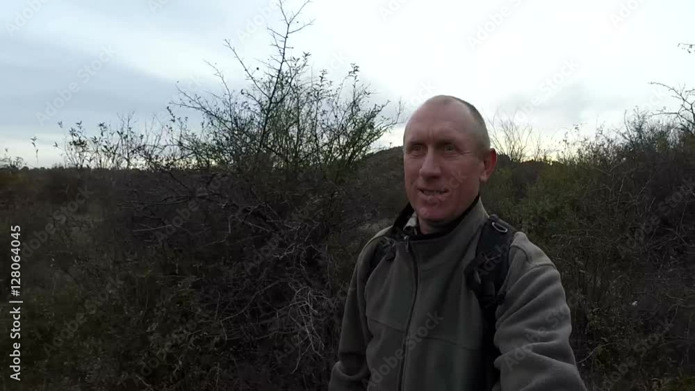 Happy man do selfie and walks outdoors on track among Happy man do selfie and walks outdoors on track among
