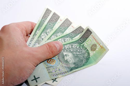 people, business, finances and money concept - close up of businessman hands holding polish money zloty (pln), paying