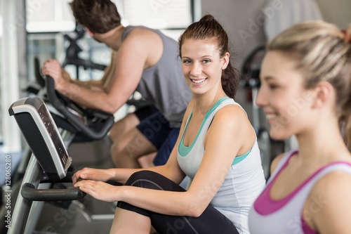 Fit people doing exercise bike