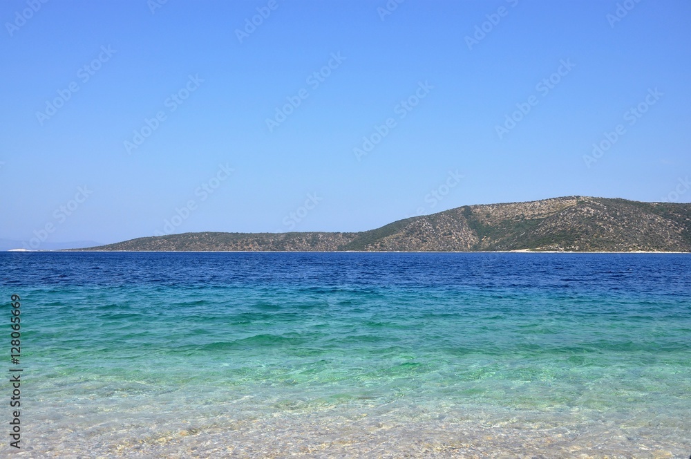 Bright azure blue ocean water in Greece, Agios Dimitrios beach in Alonissos.