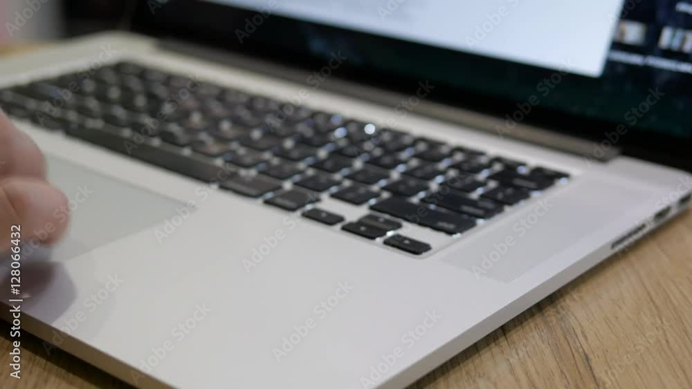 Male hands open laptop and start working, Hand fingers using touchpad of laptop computer for scrolling pages searching in internet. slider shot, pan left Male hands open laptop and start working, Hand fingers using touchpad of laptop computer for scrolling pages searching in internet. slider shot, pan left