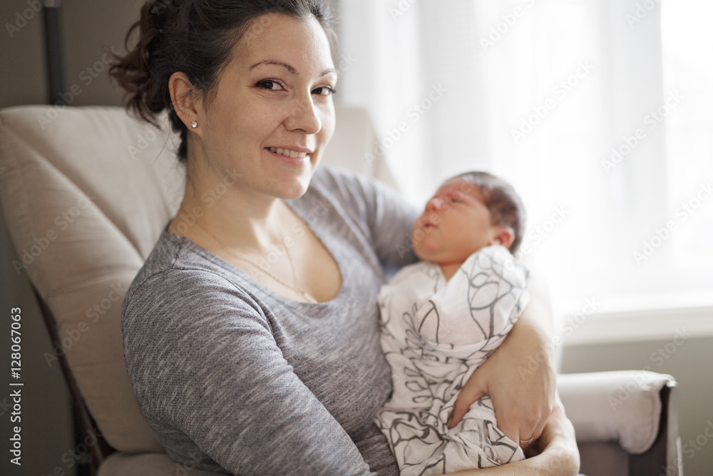 Happy mother holding adorable child baby on the living room Happy mother holding adorable child baby on the living room