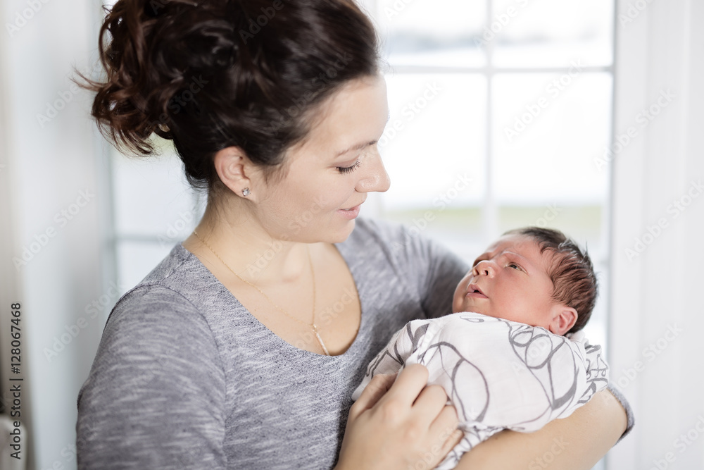 Happy mother holding adorable child baby on the living room Happy mother holding adorable child baby on the living room
