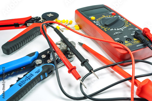 Tools and equipment for electrical work on a white background