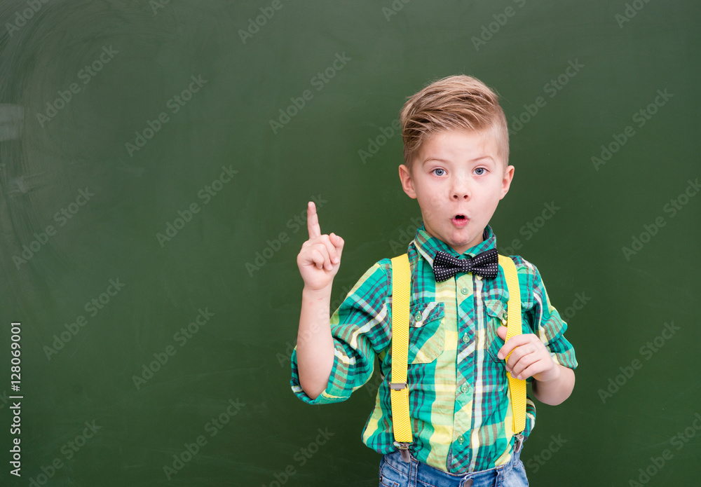 Surprised boy stands near the chalkboard Surprised boy stands near the chalkboard