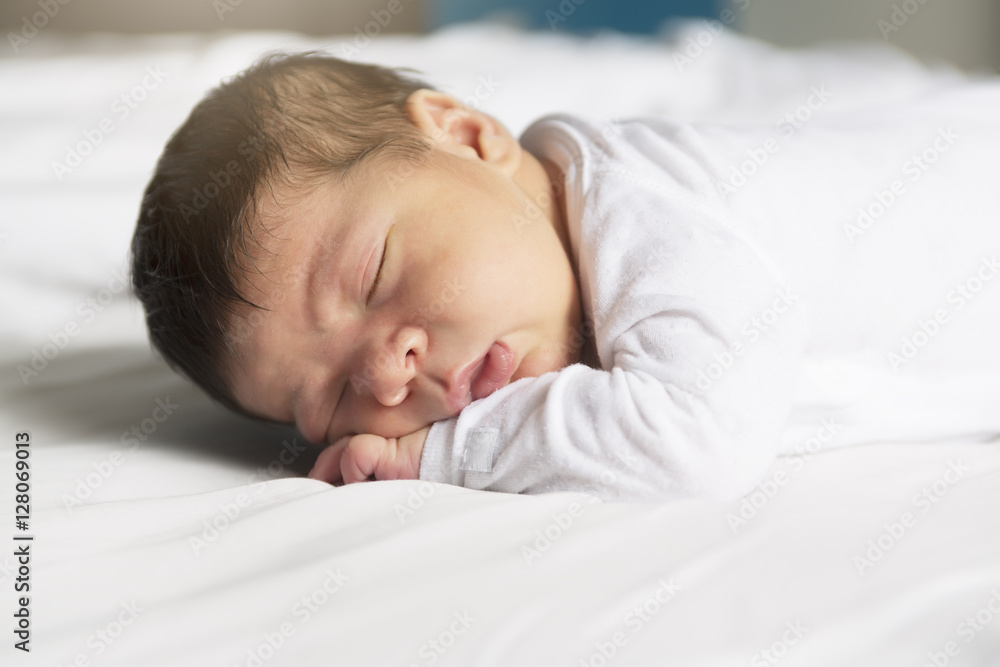 Baby sleeping on white sheet Baby sleeping on white sheet