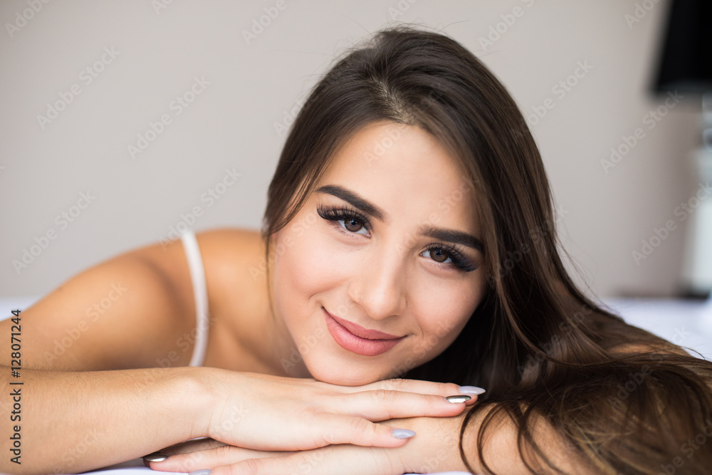 gorgeous young woman lying on her bed gorgeous young woman lying on her bed