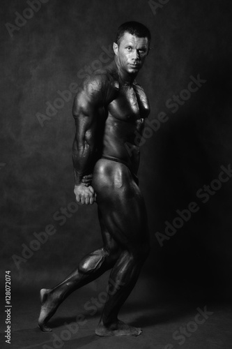 Muscular male Bodybuilder posing in studio © kanzefar