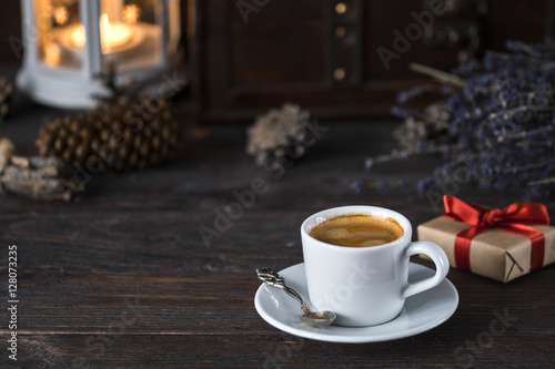 cup of aroma black espresso on wooden table with little present  lavender and decor things