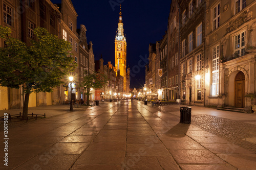 Deserted street at night in a classic medieval town in Europe with a clock tower 