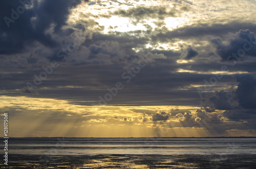 Sunset light through the clouds from the beach  Bay of Saint Mic
