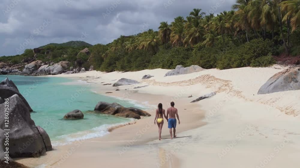 aerial video of a couple walking on tropical beach, Virgin Gorda, British Virgin Islands aerial video of a couple walking on tropical beach, Virgin Gorda, British Virgin Islands