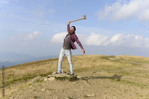 bearded man with ax on mountain