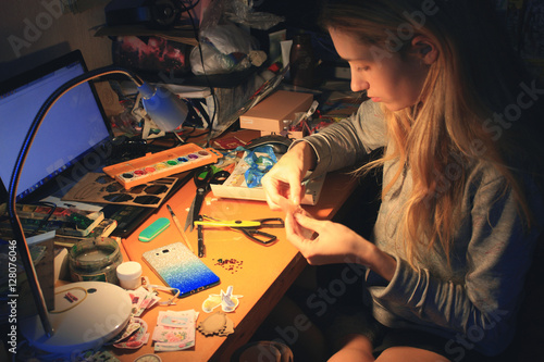 caucasian blond young woman do craft decoration at home