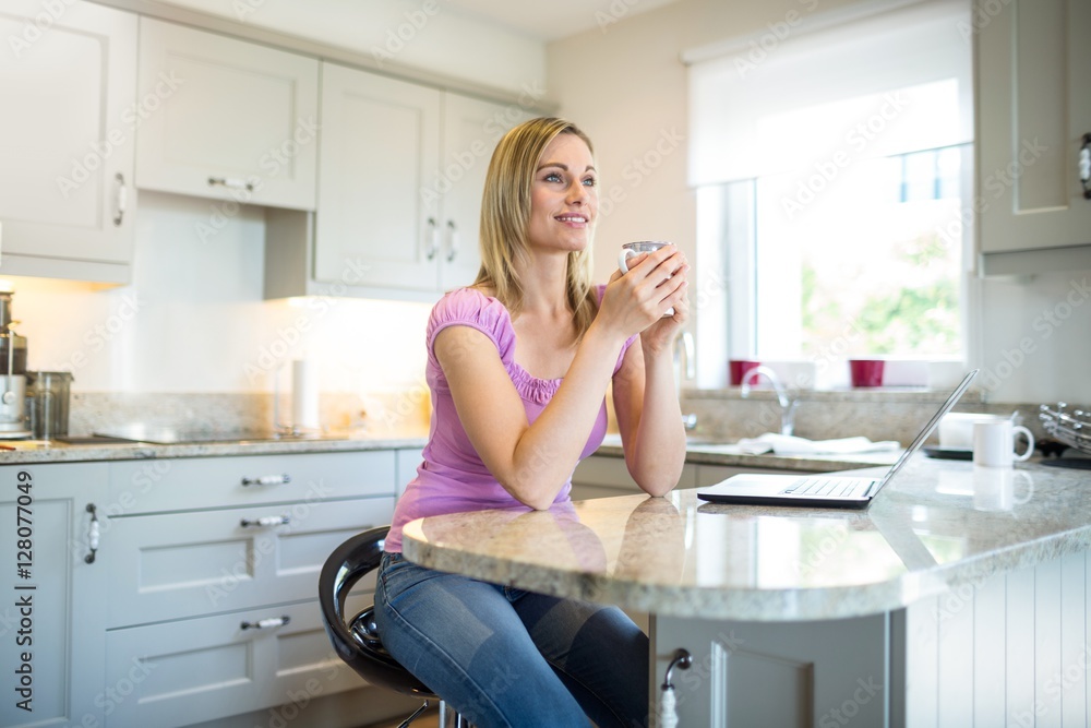 Pretty blonde woman having coffee and using laptop Pretty blonde woman having coffee and using laptop