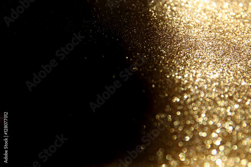 glitter vintage lights background. dark gold and black