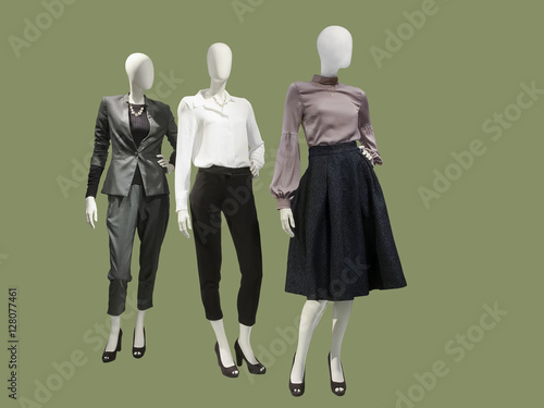 Three female mannequins dressed with fashionable clothes.
