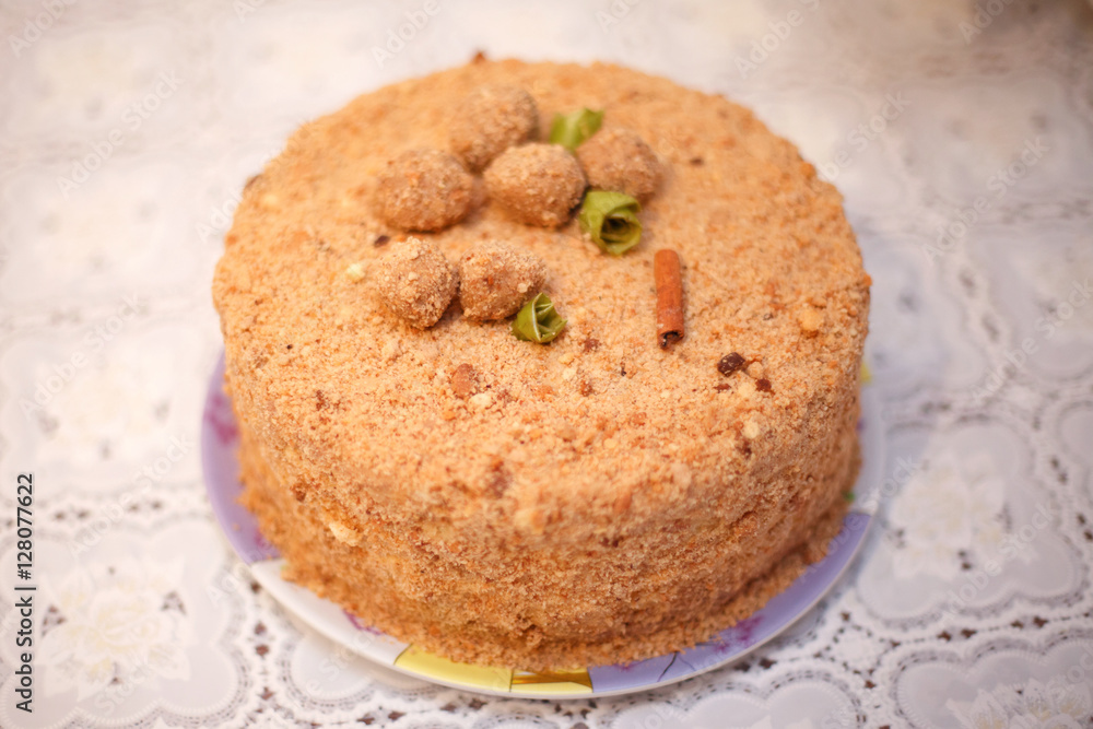 Beige round cake with cinnamon, close-up, selective focus Beige round cake with cinnamon, close-up, selective focus