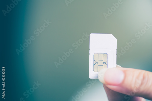 Plakat Hand holding sim card, select focus, color effect
