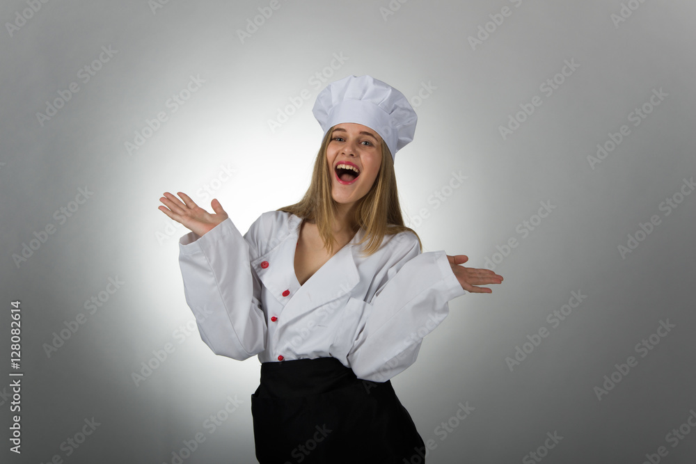Joyful girl in the hat and white coat cook Joyful girl in the hat and white coat cook