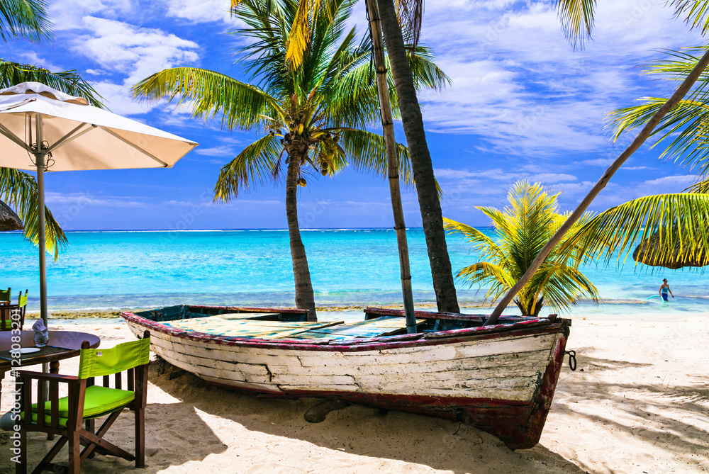 amazing tropical holidays. Beach restaurant with old boat. Mauritius island
