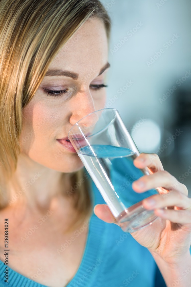 Pretty blonde woman drinking a glass of water Pretty blonde woman drinking a glass of water
