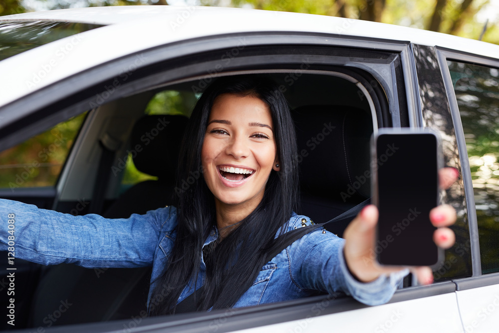 Happy woman showing mobile phone