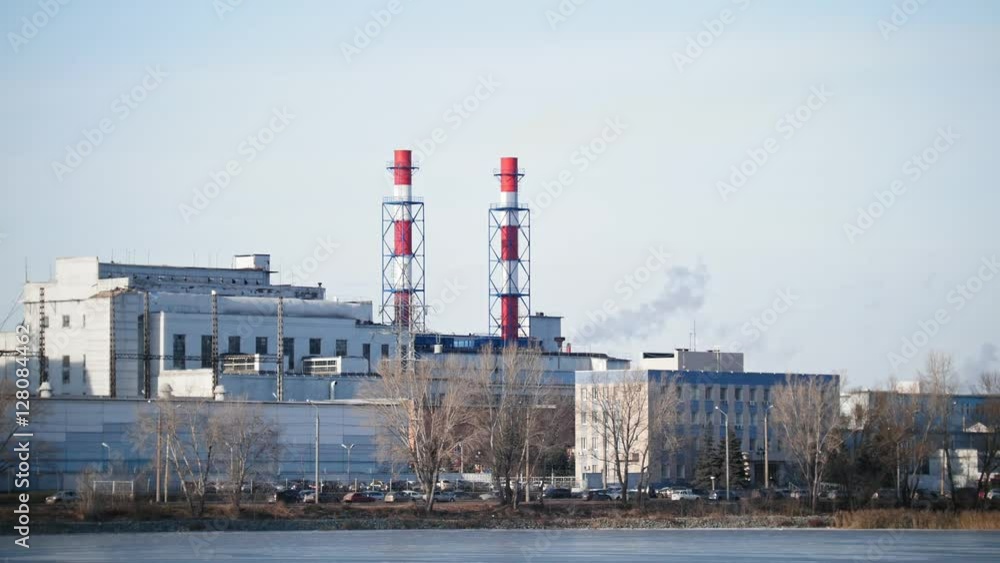 Industrial landscape - power plant at sunny day, white vapor from red tube Industrial landscape - power plant at sunny day, white vapor from red tube