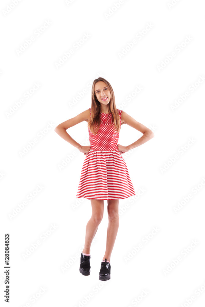 Skinny girl in cute white and red dress with hands on hips stand