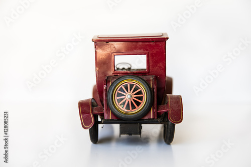 Old vintage tin toy Model A car back view with white background. photo